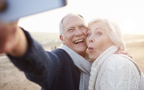 Older couple smiling.